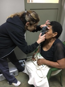 Woman getting eye exam in Fiji