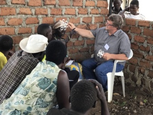 Helper with woman in Uganda